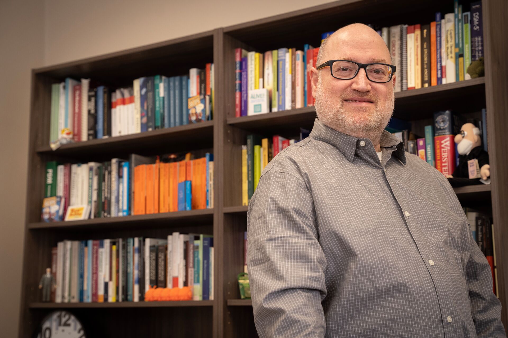 Oren Shefet in front of a bookshelf in his office