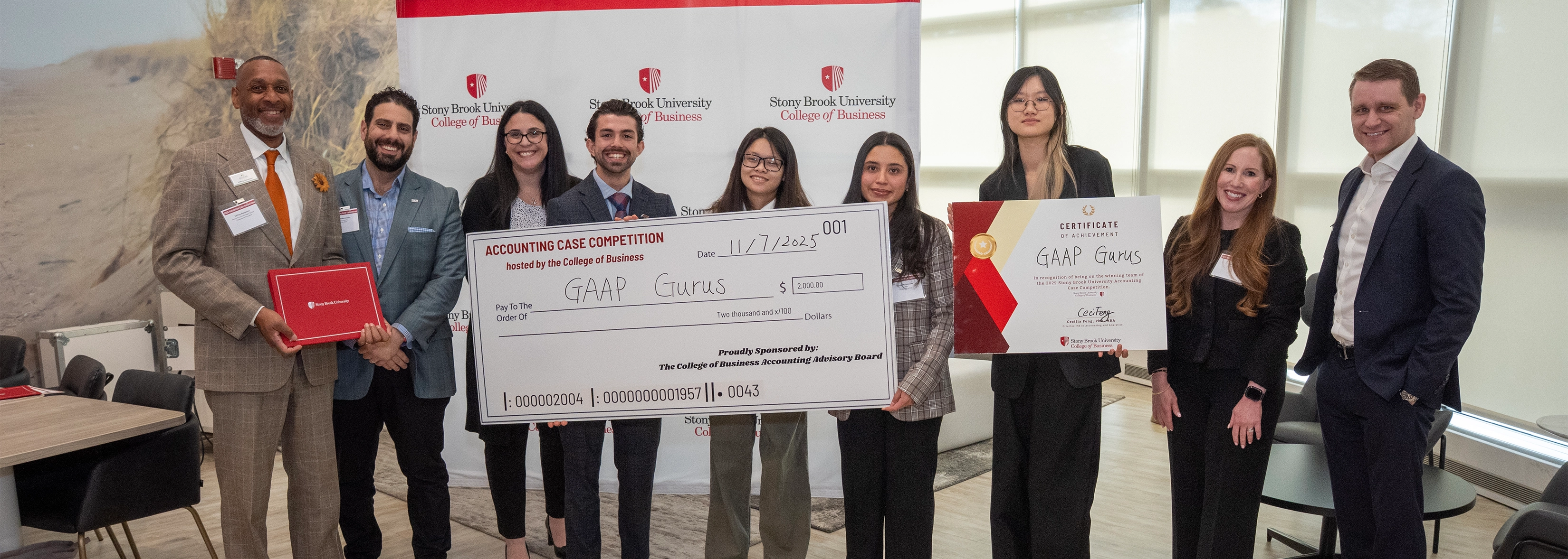 SUNY Stony Brook University College of Business Accounting Students at the Accounting Case Competition holding big check for winning