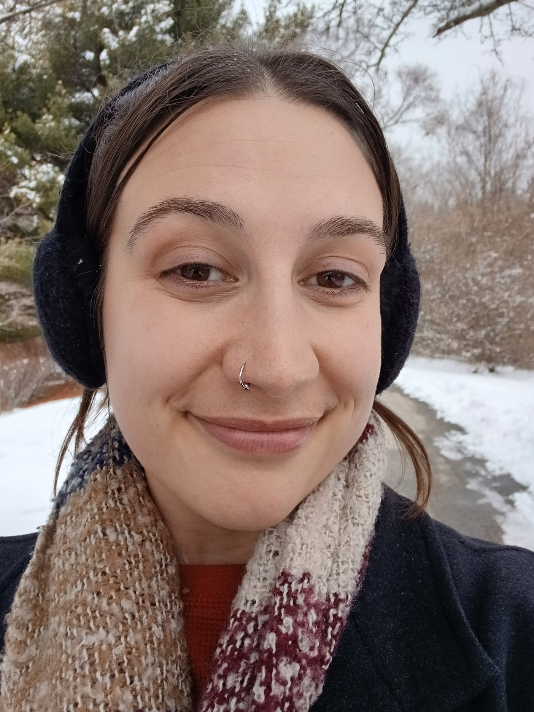 Jessica Infanzon, wearing a scarf and smiling