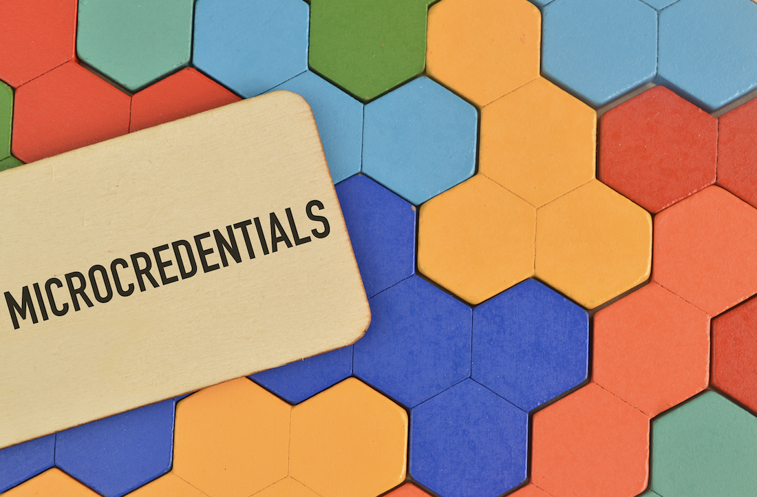 the word Microcredentials is shown over colorful tiles