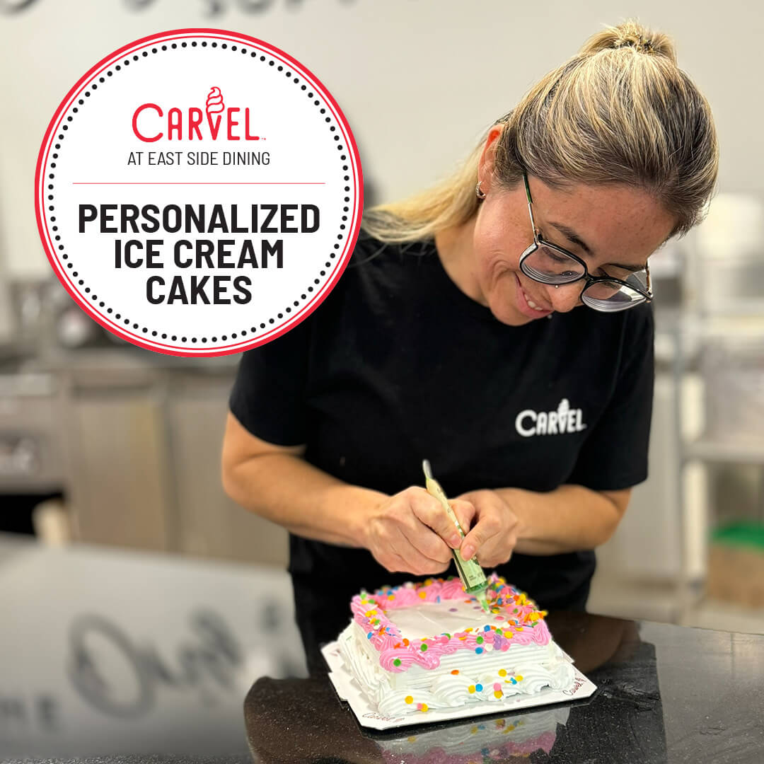 Carvel employee decorating ice cream cake