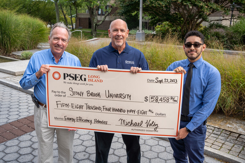 image of individuals from PSEG standing behind a large check for stony brook's rebates