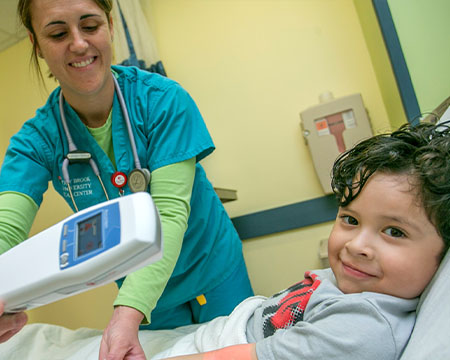 A nursing graduate student helping a child