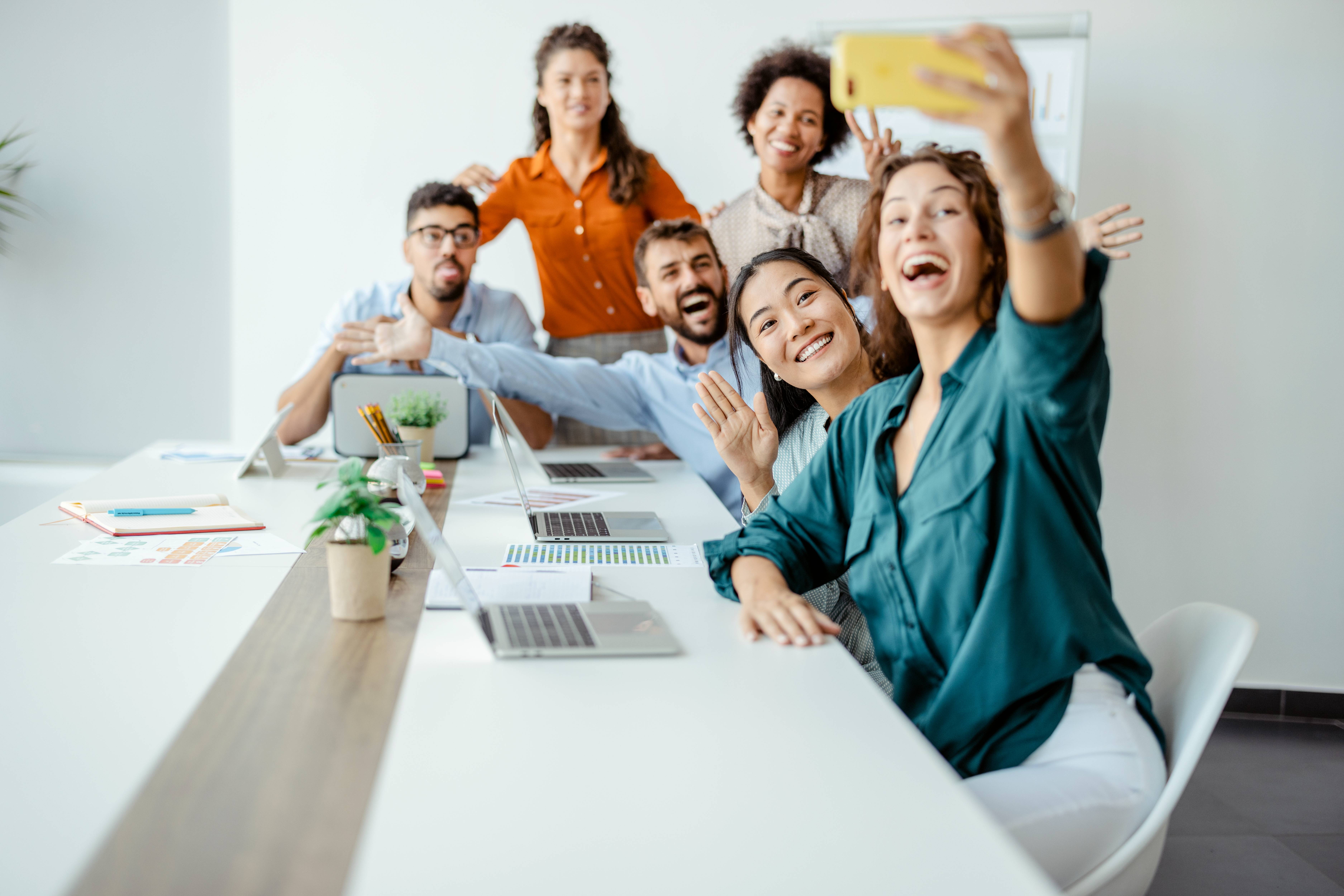 Group of colleagues enjoying and taking selfie