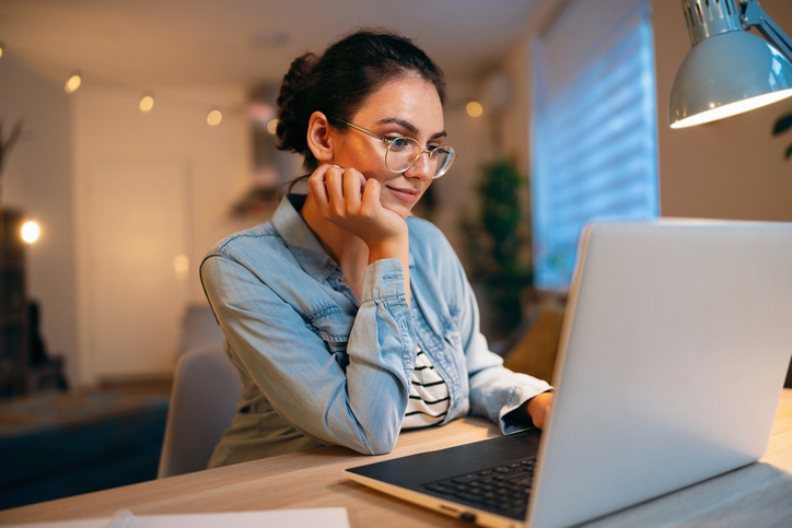 Woman at home looking at a laptop